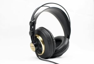 High-quality black and gold studio headphones with thick padding on a white background, ideal for music professionals.